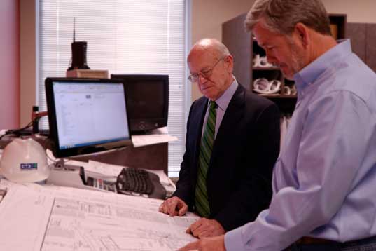 Tom Gay and Phil Rutledge look over plans